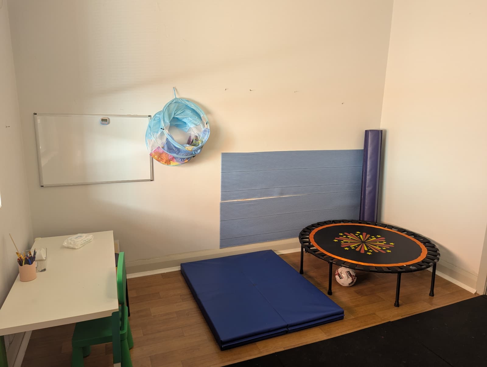 Motor skills room with trampoline, mats and work table